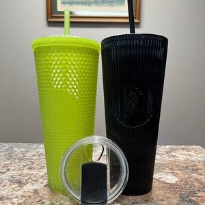 Pair of large Starbucks cups with screw on lids and straws.